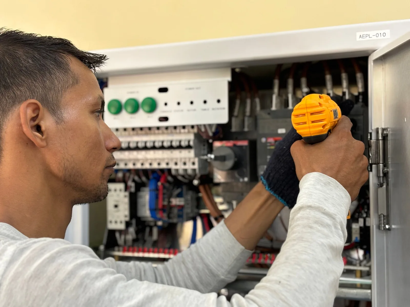 An electrician working on a commercial control panel, for panel upgrade in Salt Lake City